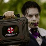 A cosplayer holding an Umbrella Corporation case, inspired by Resident Evil, ready for Halloween.